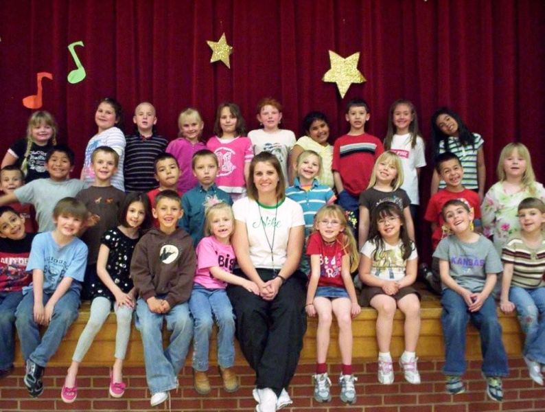 Mrs. McVey sitting with both of her 1st grade classes.